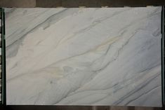 a marble slab is shown with white and grey paint on it's surface, as seen from above