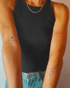 a woman with tattoos on her arms