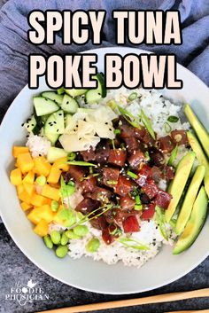 a bowl filled with rice, meat and veggies next to chopsticks