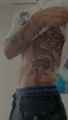 a man with a dragon tattoo on his back