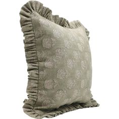 a decorative pillow with ruffled edges on a white background, it has a flower pattern