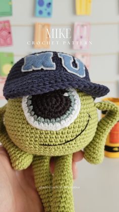 a crocheted stuffed animal with a hat on it's head and eyes