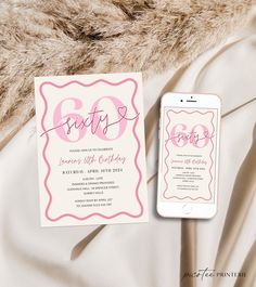 a pink and white birthday party card next to an iphone on top of a bed