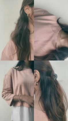 a woman with long hair standing in front of a white wall