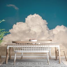 a dining room table and chairs with clouds in the background