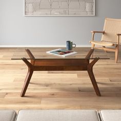 a coffee table with a book and cup on it