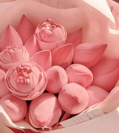 a bouquet of pink flowers in a paper bag