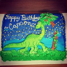 a birthday cake with a dinosaur on it