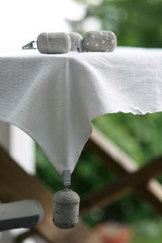 the table cloth is white and has two small rocks on it