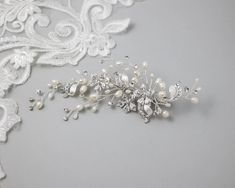 A dainty design of silver five-petal crystal flowers, matte silver ribbons, and ivory freshwater cultured pearls.Brighten your wedding day hairstyle with this lovely hair clip! It is about 5.75 inches long and 2 inches wide, on an alligator style pinch clip. Wedding Day Hairstyle, Crystal Flowers