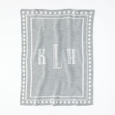 a gray and white monogrammed dish towel with the letter kl on it