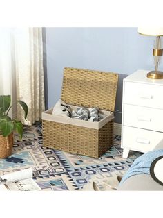 a wicker basket sitting on top of a floor next to a white dresser