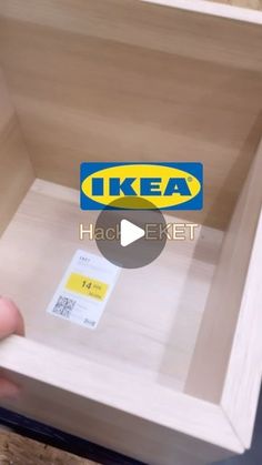 a person holding a piece of wood with a label on it that says ikea