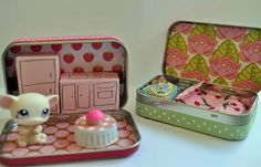 a small doll house in a tin with its contents opened and sitting next to it