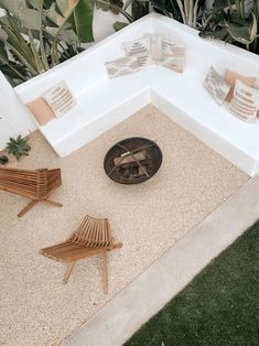 an outdoor seating area with two chairs and a fire pit