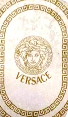 the versa logo is shown in gold on a white plate with greek border around it