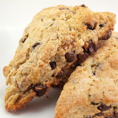 two chocolate chip cookies on a white plate