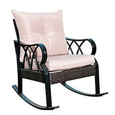 a black rocking chair with pink cushions