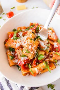 a white bowl filled with pasta and sauce