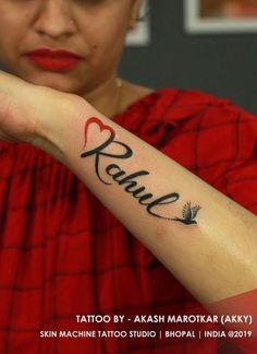 a woman with a tattoo on her arm that reads renu and has a bird in it