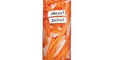 carrots and onions are arranged in a tube with labels on them that read carrot daikon