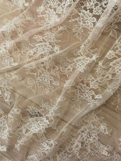 an image of white lace on fabric