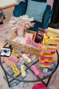 a table topped with lots of assorted items on top of a glass coffee table