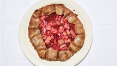 a pie with strawberries is on a white plate