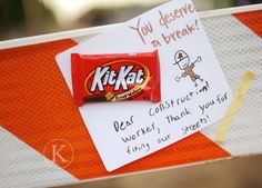 a candy bar with writing on it sitting on top of a sign that says kitkat