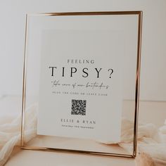 a photo frame with the words feeling tipsy on it sitting on a white surface