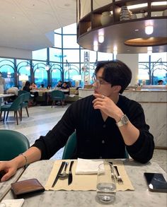 a man sitting at a table in a restaurant