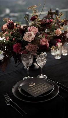 there is a black table cloth with flowers and wine glasses on it, along with the words moderne's brailled mit tollrock