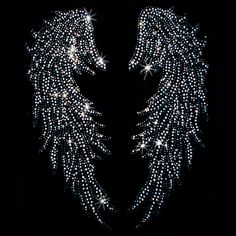 an angel's wings with sparkling stars on them