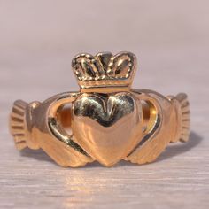 This Stunning Piece, Known As The Irish Claddagh, Is A Beautifully Crafted Claddagh Ring Signed By Solvar. The Ring Showcases The Traditional Claddagh Design, Featuring Two Hands Holding A Heart Topped With A Crown, Symbolizing Love, Loyalty, And Friendship. This Ring Is Crafted In 14 Karat Yellow Gold, Adding A Classic And Elegant Touch To Its Symbolic Design. This Exquisite Ring Is Currently A Finger Size 8 Yet Can Be Adjusted To Any Finger Size For An Additional Charge Upon Request, Ensuring A Perfect Fit. Claggagh Ring, Irish Claddagh, Heart Top, Claddagh Rings, Womens Jewelry Rings, Gold Color, Yellow Gold, Women Jewelry, Signs