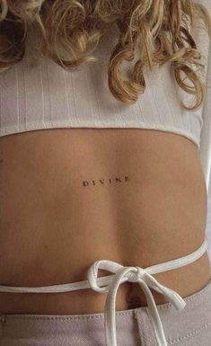 the back of a woman's stomach with her name written in cursive writing