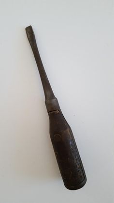 an old wooden baseball bat on a white surface