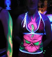 a woman standing next to another woman in a room with neon lights on her body