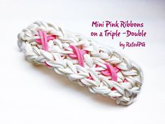 a pink ribbon is on top of a white crochet piece with the words mini pink ribbons on it