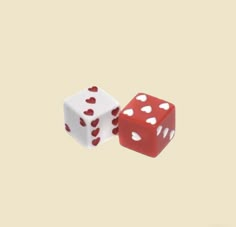 two red and white dices with hearts on the sides are facing each other in opposite directions