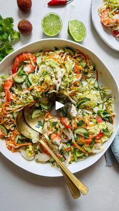 a white bowl filled with coleslaw slaw and lime wedges