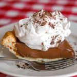 a piece of chocolate pie with whipped cream on top