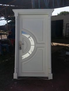 a white door with a circular design on the front and side panels that are cut in half