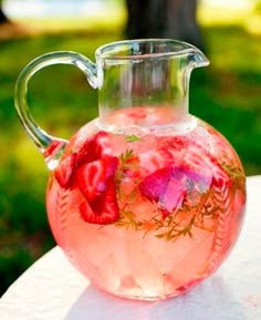 a pitcher filled with liquid sitting on top of a table