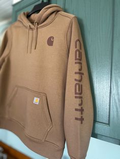 Carhartt Relaxed Fit Midweight Logo Sleeve Graphic Sweatshirt Style No: TS0288-W / 102791-B66 This Carhartt Relaxed Fit Midweight Logo Sleeve Graphic Sweatshirt can be found at Crane's Country Store, located in Williamsburg, Mo Carhartt Hoodies, Cute Cowgirl Boots, Hoodies Aesthetic, Carhartt Hoodie, Carhartt Women, Sweatshirt Style, Country Store, Birthday Wishlist, Brown Sweater