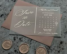 wedding save the date cards and coins on a table