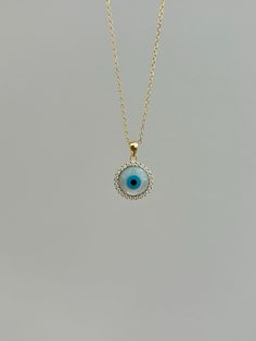 Dainty and sparkly, this Evil Eye necklace knows how to make a statement! Information: 🧿 Sterling Silver (925 stamped) | 14K Gold Plated 🧿 Simulated Mother of Pearl  🧿 AAA+ Cubic Zirconia gemstones 🧿 Hypoallergenic 🧿 Tarnish Resistant Our Evil Eye necklace features great craftsmanship from the choice of the metals to the gemstones used. In the charm, we have followed a halo design with the Evil Eye on the center. It has a beautiful luster and sparkle. The charm has a size of: 1/2" by 1/2" which is dainty and perfect for layering. Our necklace is adjustable, you can wear it at 16", 17" or 18" allowing you to find the perfect fit and create awesome stacks. Information about the Evil Eye: For centuries, the Evil Eye 🧿 has bee seen as a symbol of protection from evil and negative energie Blue Evil Eye Necklace, Gold Evil Eye Necklace, Protection From Evil, Necklace Evil Eye, Symbol Of Protection, Halo Design, Halo Pendant, Blue Evil Eye, The Evil Eye