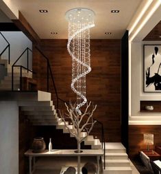 Transform any room into your own personal masterpiece with this LED Crystal Rain Dance Chandelier. This stunning design combines crystal accents with a chrome finish, creating a look that is both modern and luxurious. With sparkling crystals shimmering from the intricate raindrop design, your space will be illuminated with elegance and grace. Whether it's used to light up the entryway, lounge, or bedroom, this chandelier adds a touch of distinction and charm to any decor. From its traditional st Residential Lobby Design, Link Modern, Modern Kitchen Pendant Lights, Wall Stairs, Residential Lobby, Led Crystal Chandelier, Cafe Dining, Crystal Ceiling Light, Double Height