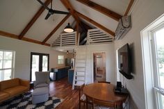 a living room filled with furniture and a flat screen tv