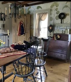 a dining room table and chairs in front of a window