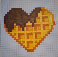 a heart made out of squares on top of a piece of paper with an orange and brown pattern